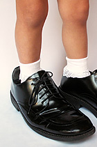 Child feet in big shoes