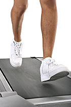 Close up of men running on treadmill